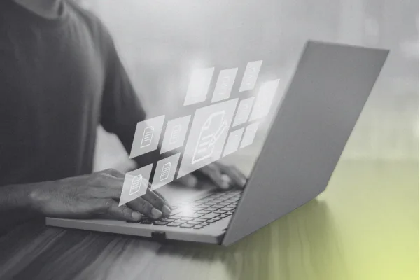 A person reviewing documents on a laptop
