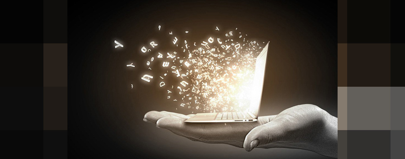 A small laptop computer held out on a hand with letters shooting out of the screen