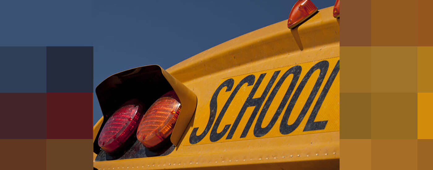 The top of a school bus with the sign SCHOOL