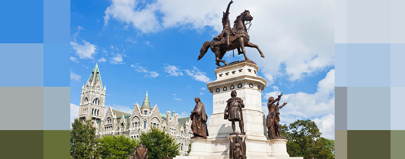 Historical statue in Virginia featuring a man on a horse with his hand up.