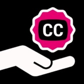 a hand holds out a closed captioning icon badge