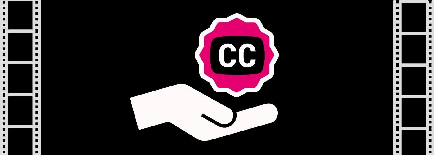 a hand holds out a closed captioning icon badge