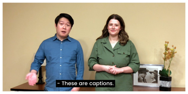 Screenshot of man and woman talking. Closed caption reads "These are captions."