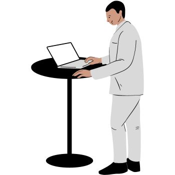 man standing at a table with a laptop