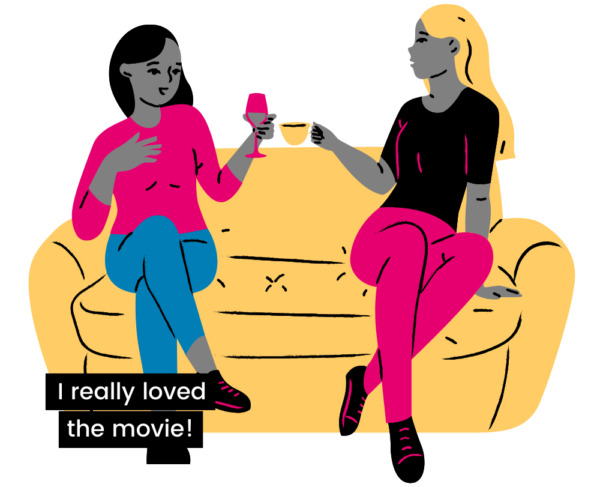 Two women sit side by side on a sofa with beverages. A closed caption with white text on a black background, positioned to the far left reads "- I really loved the movie!"