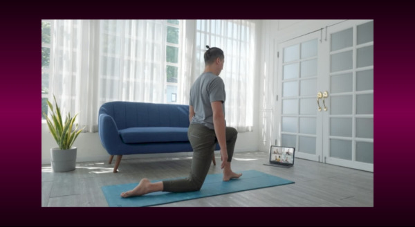 Man doing an online fitness class at home.