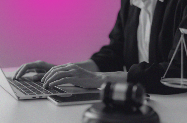 person at laptop with judge's gavel