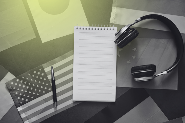 headphones and a notebook on top of different countries' flags
