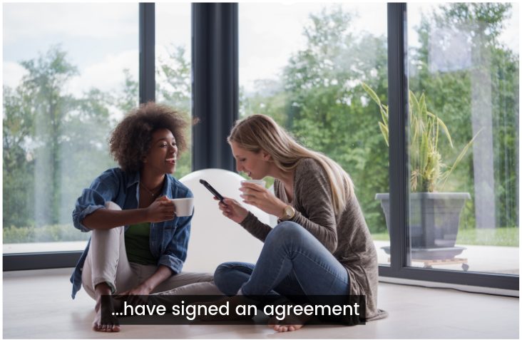 two women sit on the floor talking to each other, suddenly one says have signed an agreement