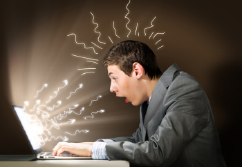 Man at Laptop With Squiggles Coming Out of Computer and Head