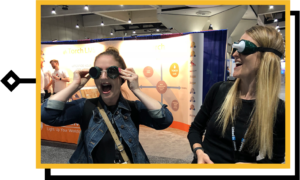 two women wearing goggles with mouths open looking surprised