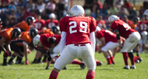 high school student plays football on the field