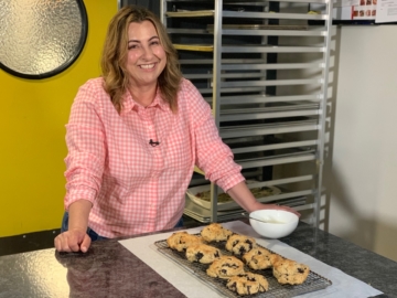 Mary Mammoliti poses in front of scones she just freshly baked.