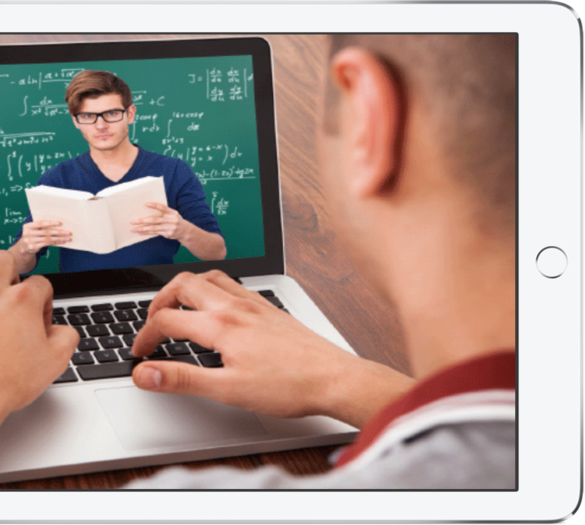 Young man at laptop watching a math video