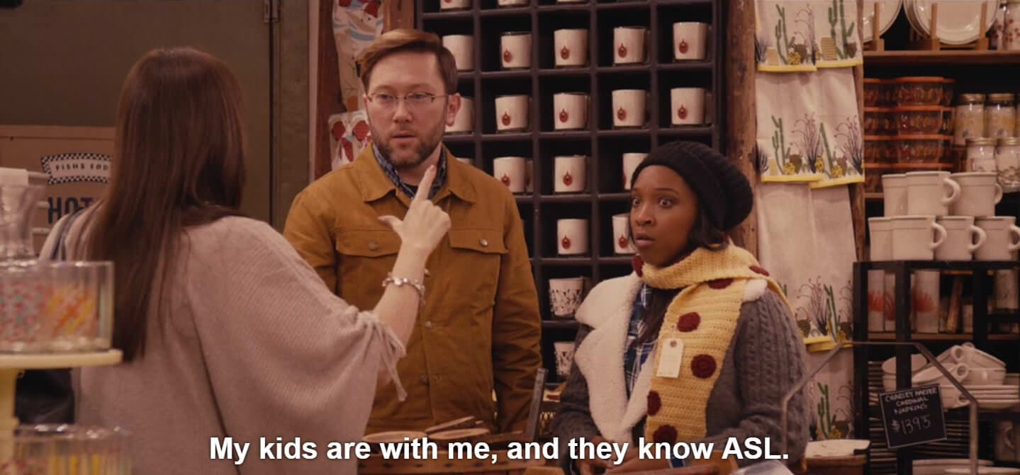A screenshot from Master of None during a scene where a woman confronts a couple having a vulgar public argument in sign language. Captions read, My kids are with me and they know ASL.