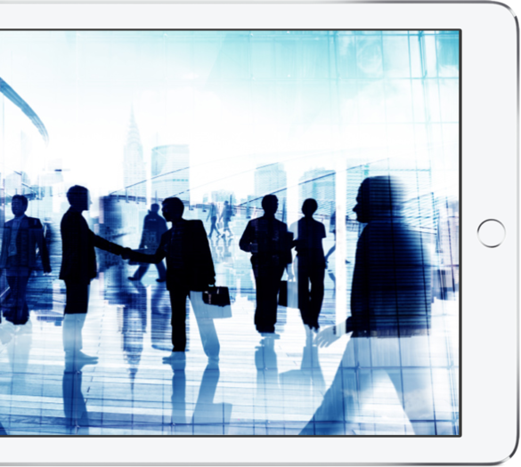 Silhouette of business professionals shaking hands and walking in front of city skyline