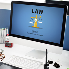 A desktop computer with a weight scale and a the word law written on screen.