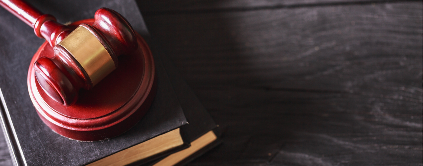 Header image - red judge's gavel atop a pile of books, represents web accessibility regulations and website ADA cases.