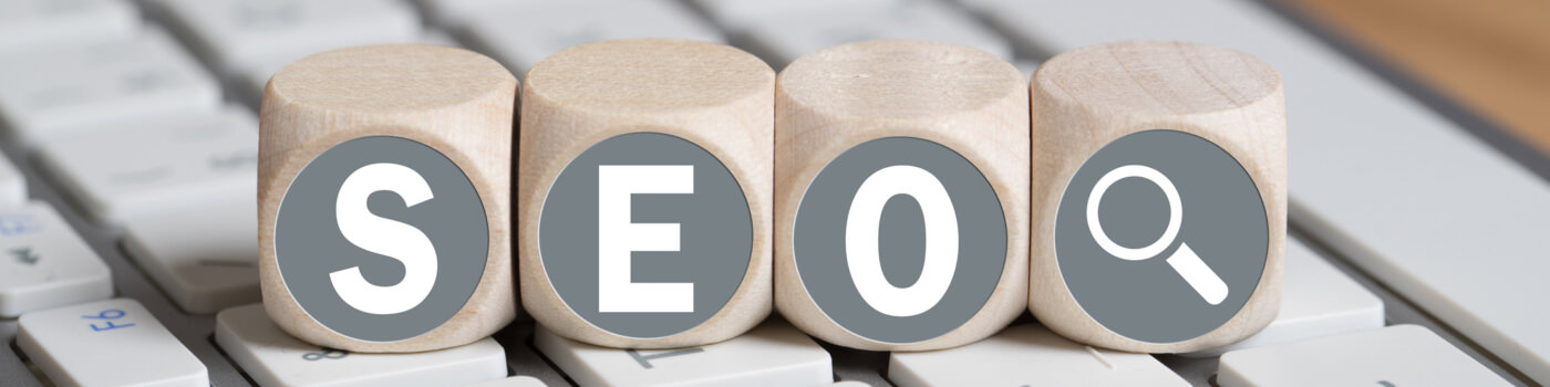 Wooden blocks on a computer keyboard spelling out SEO