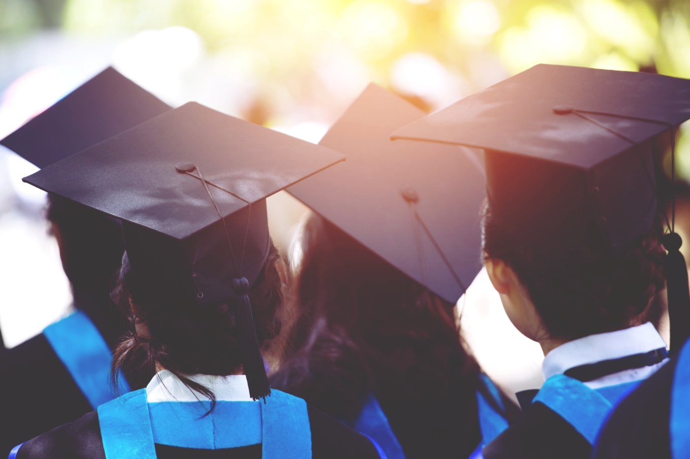 Photo of the back of students in graduation hats during commencement ceremony