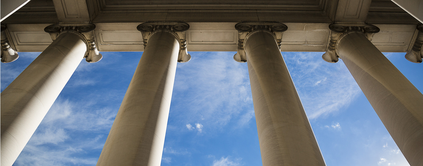 government building columns with a beautiful blue sky