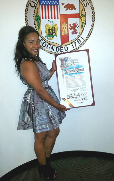Treshelle Edmond holding up her document given by the City of Los Angeles officially declaring September 28th as Treshelle Edmond Day